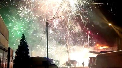 Thousands of fireworks light up sky as fire rages